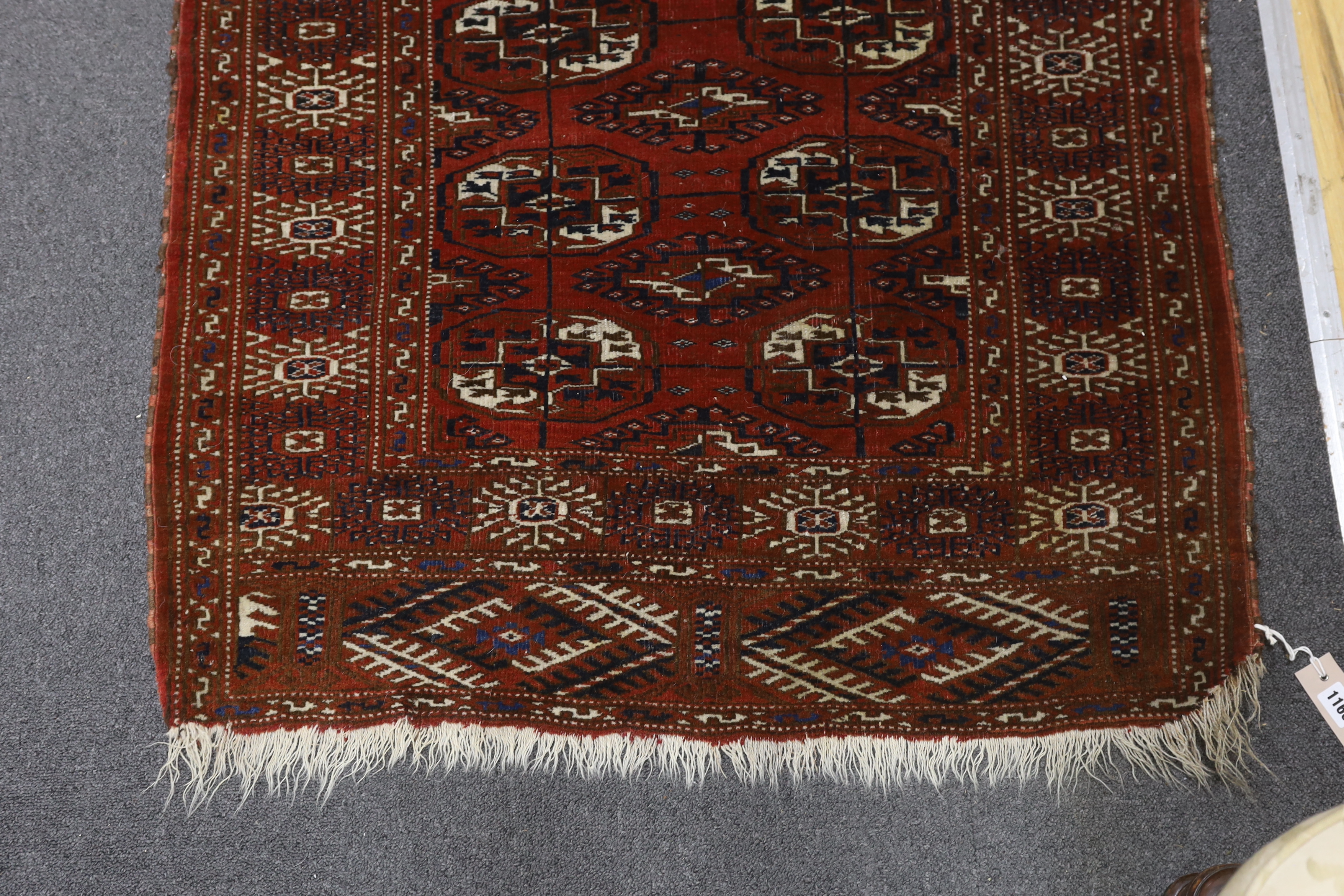 A Turkeman burgundy ground rug, 126 x 94cm